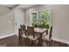 A rustic dining area features a wooden table, views to the exterior, and hardwood floors at 335 Discovery Lake Dr, Fayetteville, GA 30215