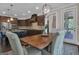 Dining room with a rustic wood table and bright natural light, with a view into the open kitchen at 335 Discovery Lake Dr, Fayetteville, GA 30215