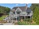 Back of gray home featuring multiple decks, lush landscaping and pool area, perfect for outdoor living at 335 Discovery Lake Dr, Fayetteville, GA 30215