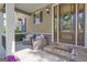 Cozy front porch with seating, stone accents, and a welcoming front door with glass panels at 335 Discovery Lake Dr, Fayetteville, GA 30215