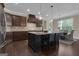 Kitchen and dining area with dark wood cabinetry, granite countertops, and stainless steel appliances at 335 Discovery Lake Dr, Fayetteville, GA 30215