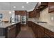 Well-equipped kitchen with stainless appliances, granite counters, and dark wood cabinetry, plus a gas range at 335 Discovery Lake Dr, Fayetteville, GA 30215