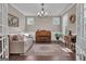 Cozy living room with hardwood floors, wainscoting, piano, sofa, and natural light from windows at 335 Discovery Lake Dr, Fayetteville, GA 30215