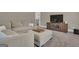 Large sectional couch in carpeted living room with media center and neutral decor at 335 Discovery Lake Dr, Fayetteville, GA 30215