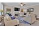 Bright living room with fireplace, plush seating, modern decor, hardwood floors, and a ceiling fan at 335 Discovery Lake Dr, Fayetteville, GA 30215