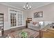 Sunlit room with hardwood floors, decor, and views into adjacent rooms through glass french doors at 335 Discovery Lake Dr, Fayetteville, GA 30215