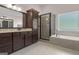 Nicely designed bathroom with shower, soaking tub, vanity with granite countertop and under-mount sink at 335 Discovery Lake Dr, Fayetteville, GA 30215