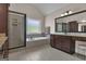Well-lit bathroom with tiled floor, walk-in shower, soaking tub, and vanity with granite countertop at 335 Discovery Lake Dr, Fayetteville, GA 30215