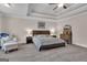 Spacious main bedroom features a tray ceiling, ceiling fan, and sitting area at 335 Discovery Lake Dr, Fayetteville, GA 30215
