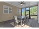 Screened-in porch with an outdoor dining setup, offering a pleasant view and comfortable dining space at 335 Discovery Lake Dr, Fayetteville, GA 30215