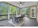 Relaxing screened porch with wooded view, features a dining table and a ceiling fan at 335 Discovery Lake Dr, Fayetteville, GA 30215