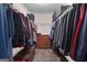 Large walk-in closet contains rods for hanging clothes and shelving for folded items and storage at 335 Discovery Lake Dr, Fayetteville, GA 30215