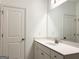 Bright bathroom featuring a white vanity with a large mirror and white door at 3865 Shelleydale Dr # 82, Powder Springs, GA 30127