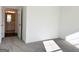 Bedroom with plush gray carpeting and doorway view to adjacent bathroom at 3865 Shelleydale Dr # 82, Powder Springs, GA 30127