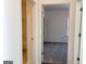 Hallway view into a bedroom with neutral walls and plush carpeting at 3865 Shelleydale Dr # 82, Powder Springs, GA 30127