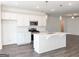 Open concept kitchen features a large island with sink and stainless appliances at 3865 Shelleydale Dr # 82, Powder Springs, GA 30127