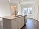 Kitchen island features a sink, stainless steel dishwasher, and quartz countertop at 3865 Shelleydale Dr # 82, Powder Springs, GA 30127