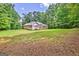 Large backyard with a well-kept lawn, backing up to a wooded area providing privacy at 250 Kari Glen Dr, Fayetteville, GA 30215