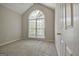 Cozy bedroom with a large arched window and neutral decor at 250 Kari Glen Dr, Fayetteville, GA 30215