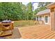 Outdoor deck with grill, overlooking a large grassy lawn and mature trees at 250 Kari Glen Dr, Fayetteville, GA 30215