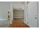 Bright foyer with hardwood floors, a white front door, and decorative columns with open access to carpeted living room at 250 Kari Glen Dr, Fayetteville, GA 30215