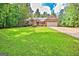 Charming single-story brick home featuring an attached garage, a well-manicured lawn and mature trees at 250 Kari Glen Dr, Fayetteville, GA 30215