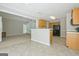 Spacious eat-in kitchen featuring tile flooring, a bar counter, and wood cabinetry at 250 Kari Glen Dr, Fayetteville, GA 30215