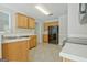Well-lit kitchen boasts tile flooring, black appliances, and natural-finish cabinetry at 250 Kari Glen Dr, Fayetteville, GA 30215