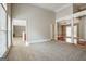 Open-concept living room featuring neutral walls and carpet, perfect for entertaining at 250 Kari Glen Dr, Fayetteville, GA 30215