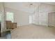 Spacious carpeted living room features a fireplace and custom built-in shelving at 250 Kari Glen Dr, Fayetteville, GA 30215