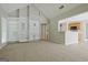 Open floor plan living room with built in shelves and a view of the kitchen area at 250 Kari Glen Dr, Fayetteville, GA 30215