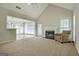 Open living room with a fireplace and a view of the sunroom through a large opening at 250 Kari Glen Dr, Fayetteville, GA 30215