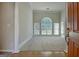 Bright, carpeted living room featuring a large window and decorative columns at 250 Kari Glen Dr, Fayetteville, GA 30215