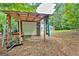Covered storage area and exterior of outbuilding with house in the background at 250 Kari Glen Dr, Fayetteville, GA 30215
