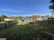 Large back yard with grass, wooden fence, trees and neighboring houses at 4092 River Mist Ct, Lithonia, GA 30038