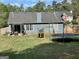 Spacious back yard with grass, wooden fence, trampoline, play set and trees at 4092 River Mist Ct, Lithonia, GA 30038