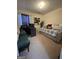 Neutral bedroom with a daybed, workspace, and seating area at 4092 River Mist Ct, Lithonia, GA 30038