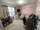 Bright bedroom with pink walls, a window, and furnishings at 4092 River Mist Ct, Lithonia, GA 30038