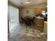 Dining area with tile floor, sliding glass doors, and view of the eat-in kitchen at 4092 River Mist Ct, Lithonia, GA 30038