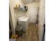 Well-equipped laundry room with washer, dryer, overhead storage and neutral walls at 4092 River Mist Ct, Lithonia, GA 30038