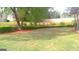 The manicured backyard has an enclosed patio, green lawn, and trimmed landscaping for ultimate relaxation at 4955 Highland Lakes Dr, South Fulton, GA 30349