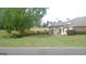 Grassy backyard of home features a covered patio with outdoor furniture and mature trees at 4955 Highland Lakes Dr, South Fulton, GA 30349