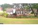 Landscaped backyard showing large yard, trees and shrubbery around the back of the house at 4955 Highland Lakes Dr, South Fulton, GA 30349