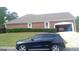 Spacious garage with room for multiple vehicles, attached to a brick home with manicured landscaping at 4955 Highland Lakes Dr, South Fulton, GA 30349
