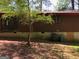 Exterior backyard view of a one-story house with wood siding and a tree at 6154 Green Acres Sw Dr, Covington, GA 30014