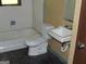 Interior bathroom featuring a toilet, sink, shower-tub combo, and patterned flooring at 6154 Green Acres Sw Dr, Covington, GA 30014