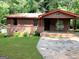 Single story house with brick foundation and brown siding surrounded by trees at 6154 Green Acres Sw Dr, Covington, GA 30014