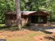 Exterior front elevation of a one story wood clad home with brick foundation and support columns at 6154 Green Acres Sw Dr, Covington, GA 30014