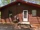 Rear exterior of a one-story house showcasing the wood siding and back door at 6154 Green Acres Sw Dr, Covington, GA 30014