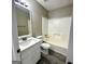 Neutral bathroom features a shower-tub, vanity, and wood-look flooring at 2204 Liberty Sw Ln, Conyers, GA 30094